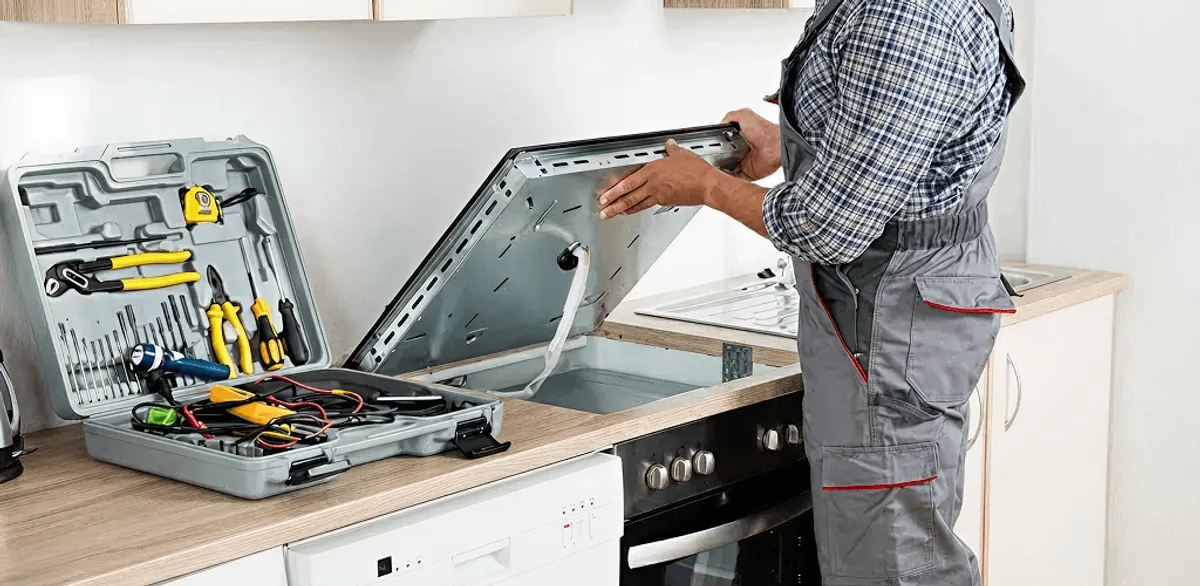 Handyman repairing a cooktop and checking wiring connections in Irvine, CA